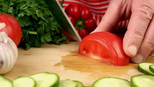 Slicing Fresh Tomato on Wooden Board