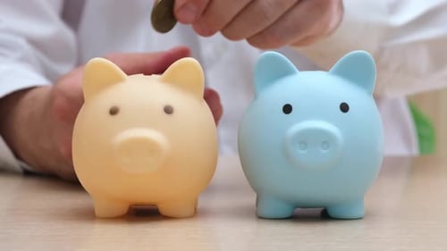 Businessman Throws Coins Into Piggy Banks in Turn Investments Diversification