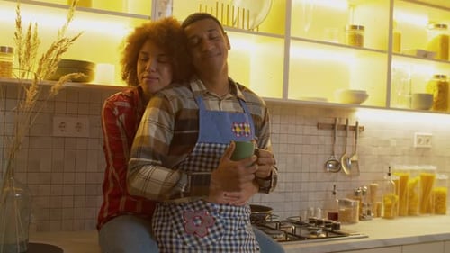 Loving Couple Embracing in Bright Kitchen at Home
