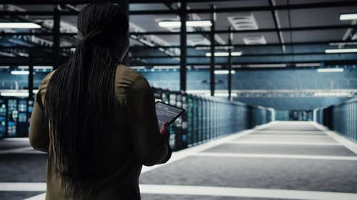 Engineer in Data Center Using Tablet to Deploy Secure Server Architecture