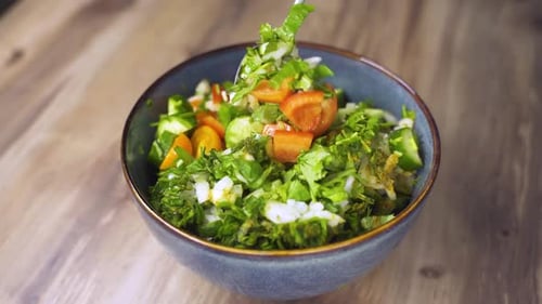 Adding Fresh Vegetables to a Vibrant Salad Bowl