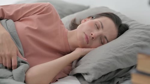 Woman Sleeping Peacefully in Bed
