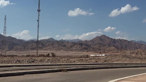 A view of a Mountain in desert from a car on a road, trucking shot