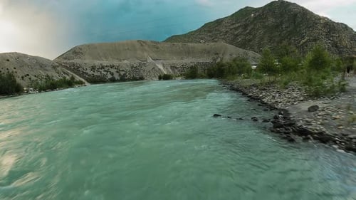 Mountain River Surges Through Highland Valley