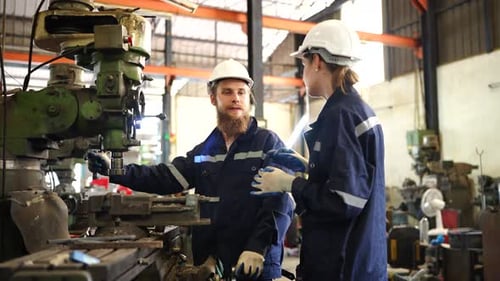 Factory Worker is Setting Up CNC Lathe Machine