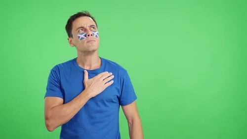 Man Listening to the Scotland National Anthem with Solemnity