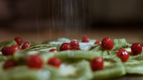 Powdered Sugar Sprinkled onto Kiwi and Currant Dessert