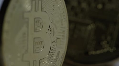 Crypto Currency - Bitcoin rack focus from coins