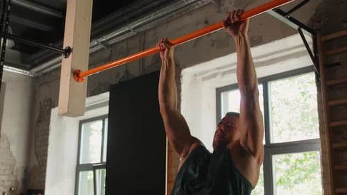 Fitness, Sport and Lifestyle Concept - Young Man Exercising on Horizontal Bar