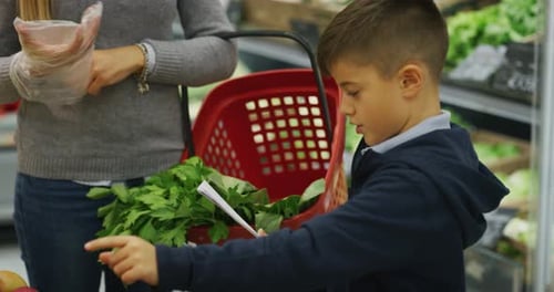 Authentic close up shot of happy mother with basket and son are having fun while shopping for groc