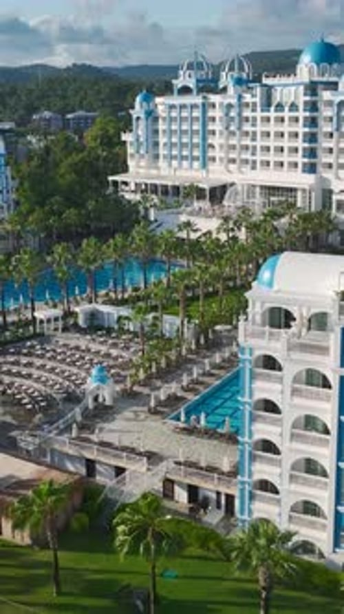 Vertical Video Stunning Coastal Hotel with Elegant Pools Scenic Piers and Pristine Mediterranean