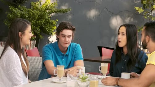 Friends Chatting over Coffee at an Outdoor Cafe