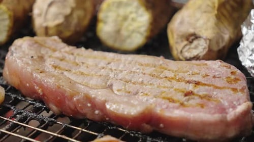 Pork and Sweet Potato Cooking on a Grill