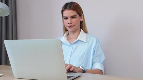 Happiness young businesswoman using laptop computer on desk in living room at home office.
