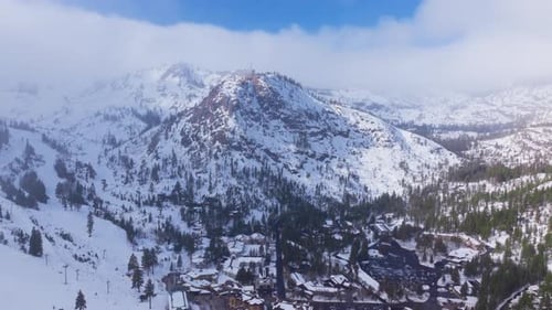 Light Snowfall Over Mountain Resort at Palisades Tahoe California USA