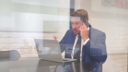 Professional Man Speaking on Smartphone in Modern Office