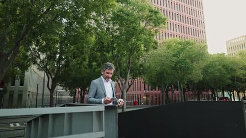 Man in Suit Drinking Coffee in Urban Setting