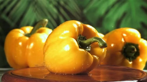 Yellow Sweet Pepper Falls on a Wet Board Filmed on a Highspeed Camera at 1000 Fps