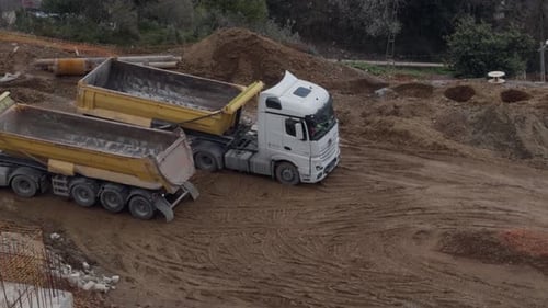 Aerial View of Dump Trucks at Construction Site