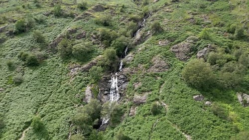 Waterfall Cascading Down Lush Green Hillside