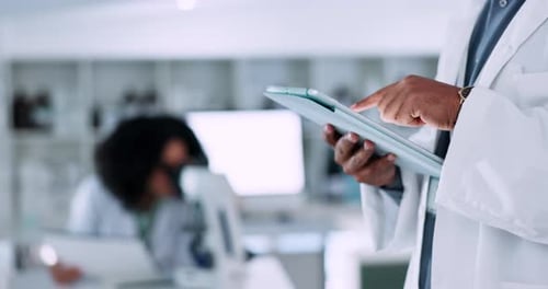 Doctor Using Tablet in Modern Hospital Laboratory