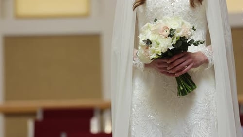 Bride in White Dress Holding Wedding Bouquet
