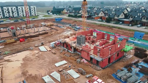 Construction Site with Cranes Building New Houses
