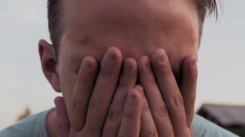 A Young Guy's Face Is CloseUp From Behind Against The Background Of A Lake