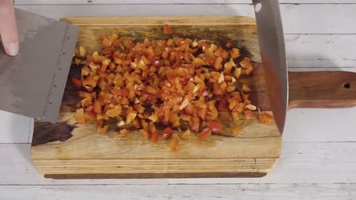 Dicing Red Peppers on Wooden Chopping Board