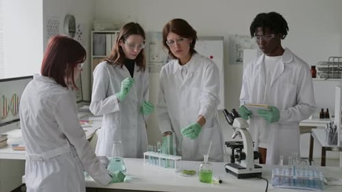 Students and Their Science Teacher Discussing Research Results in Lab