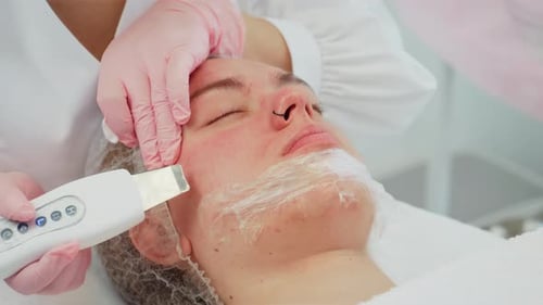 Woman Receiving Facial Ultrasound Treatment in Beauty Clinic