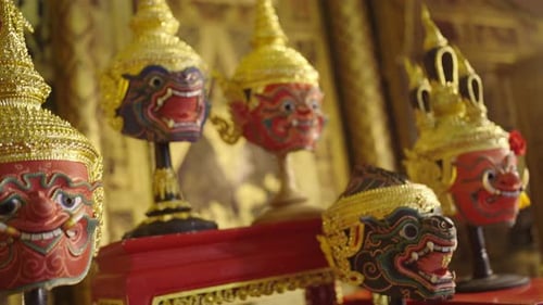 Close up of beautiful ancient traditional Thai pattern Pantomime or Khon masks are set up on shelf