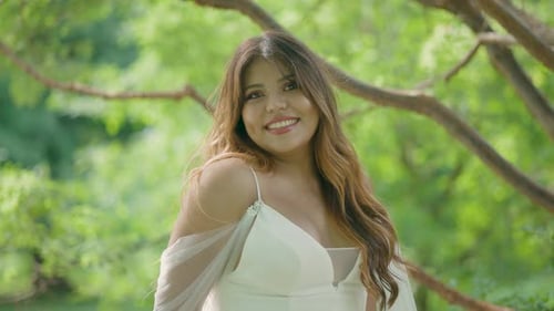 Smiling Woman in White Dress in Green Park