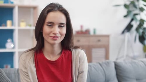 Smiling Young Woman Looking at Camera Indoors