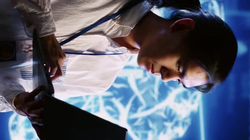 Focused Young Adult Works on Laptop