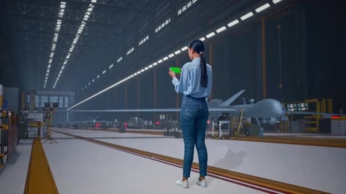 Asian Female Professional Use Green Screen Smartphone, Military Drone Hangar