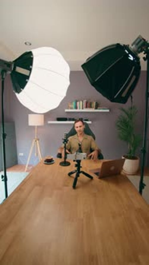 A Content Creator is Filming a Video in Their Home Studio Using Professional Equipment and Lighting