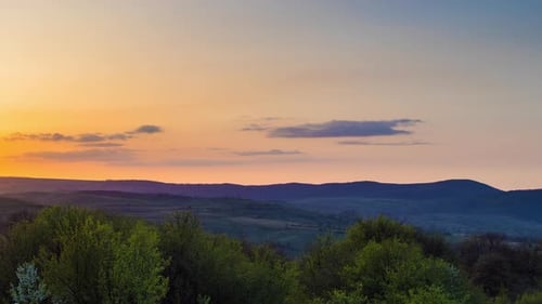 Field with Plants in the Valley Against the Backdrop of the Sunset Sky in Bulgaria