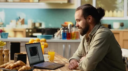 Man Using Laptop for Online Video Content on Streaming Platform