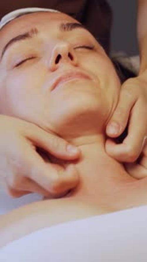 Relaxing facial massage for woman in spa
