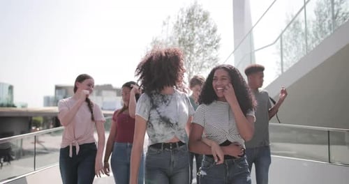 Group of teenagers walking through city
