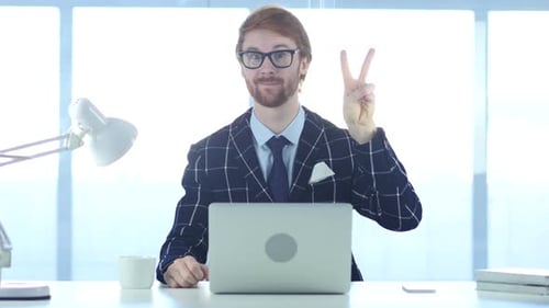 Redhead Businessman with Winning Gesture at Work Victory