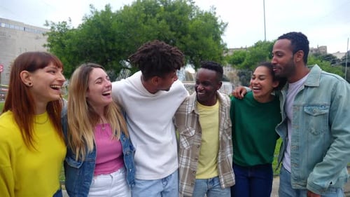Young Group of Happy Diverse People Hugging Each Other Laughing Together Outdoor