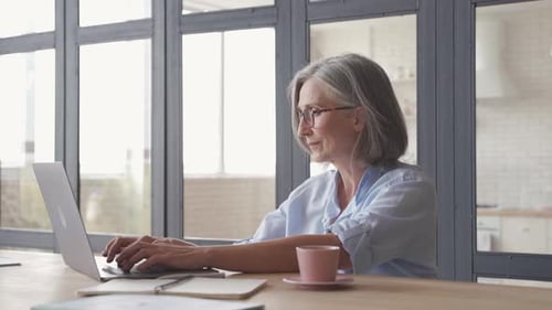 Mature Woman Using Laptop at Home