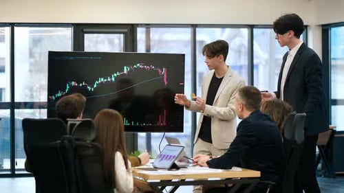 Two young workers leading business meeting in an office, discussing the topic of cryptocurrencies wi
