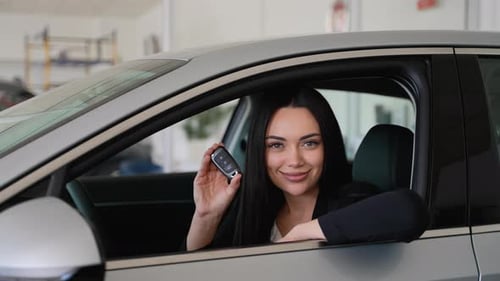 Woman Sitting Inside New Car Holding Car Keys