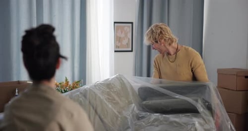 Couple resting on sofa in new home