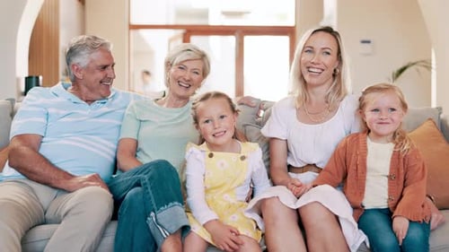Happy Multi-Generational Family Sitting Together on Sofa