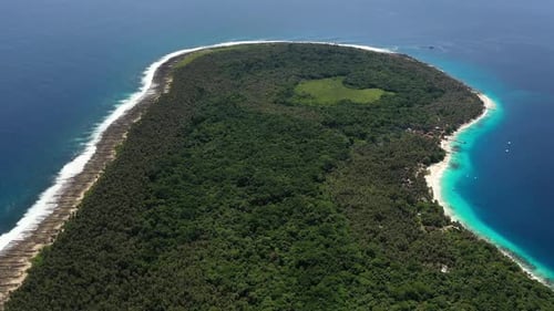 Aerial view of jungle and palm tree covered island with beautiful beach in North Sumatra, Indonesia