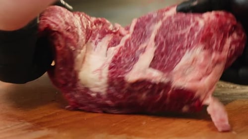 Chef Preparing Raw Beef on Cutting Board